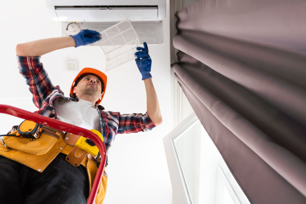 Technician busy doing Air Duct Cleaning Aurora IL
