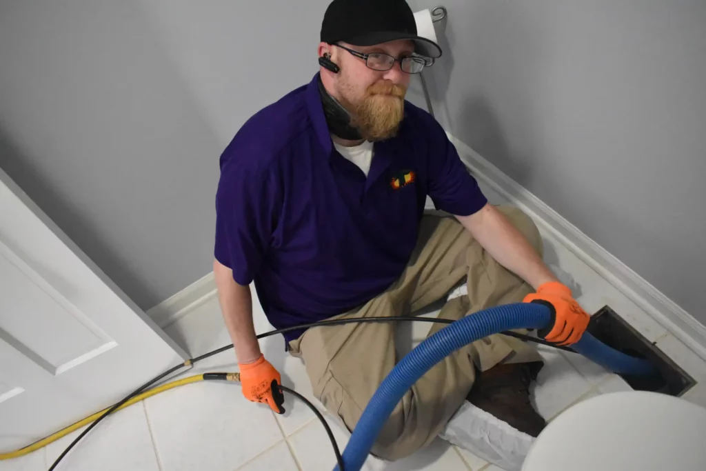 Bearded technician happy to perform air duct cleaning services