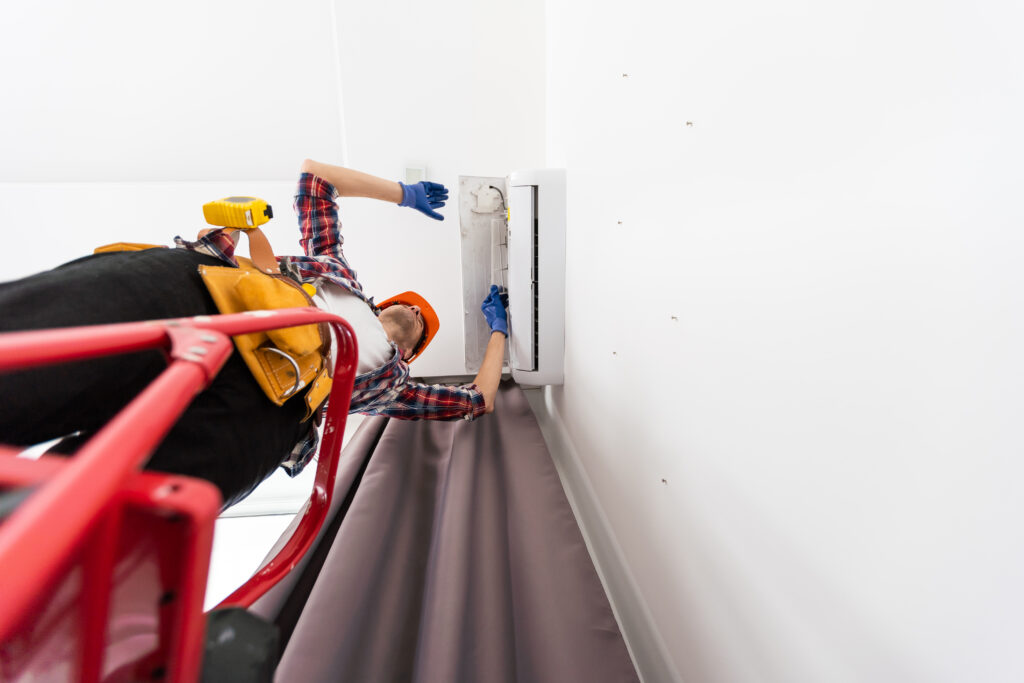A professional technician cleaning HVAC system ducts, illustrating the benefits of air duct cleaning for improved indoor air quality and energy efficiency.