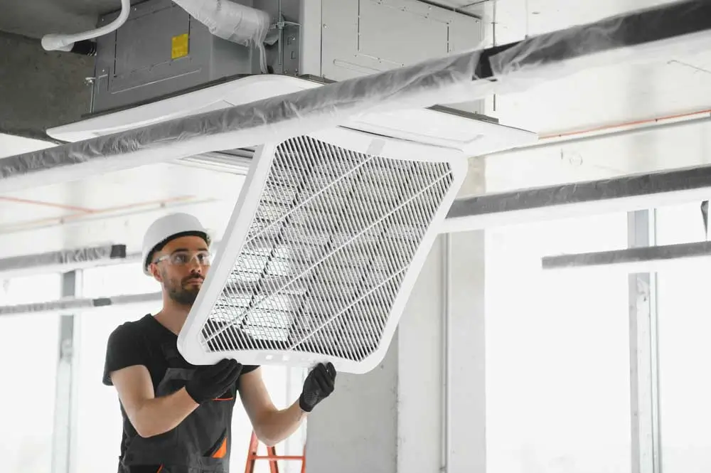 Professional double checking his home repair chicago work following an Air Duct Cleaning Wheaton IL service